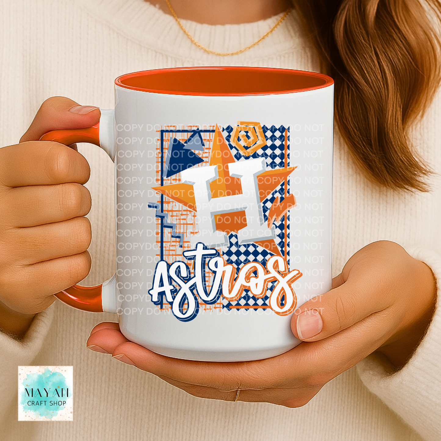 Person holding a mug with a vibrant design and orange interior