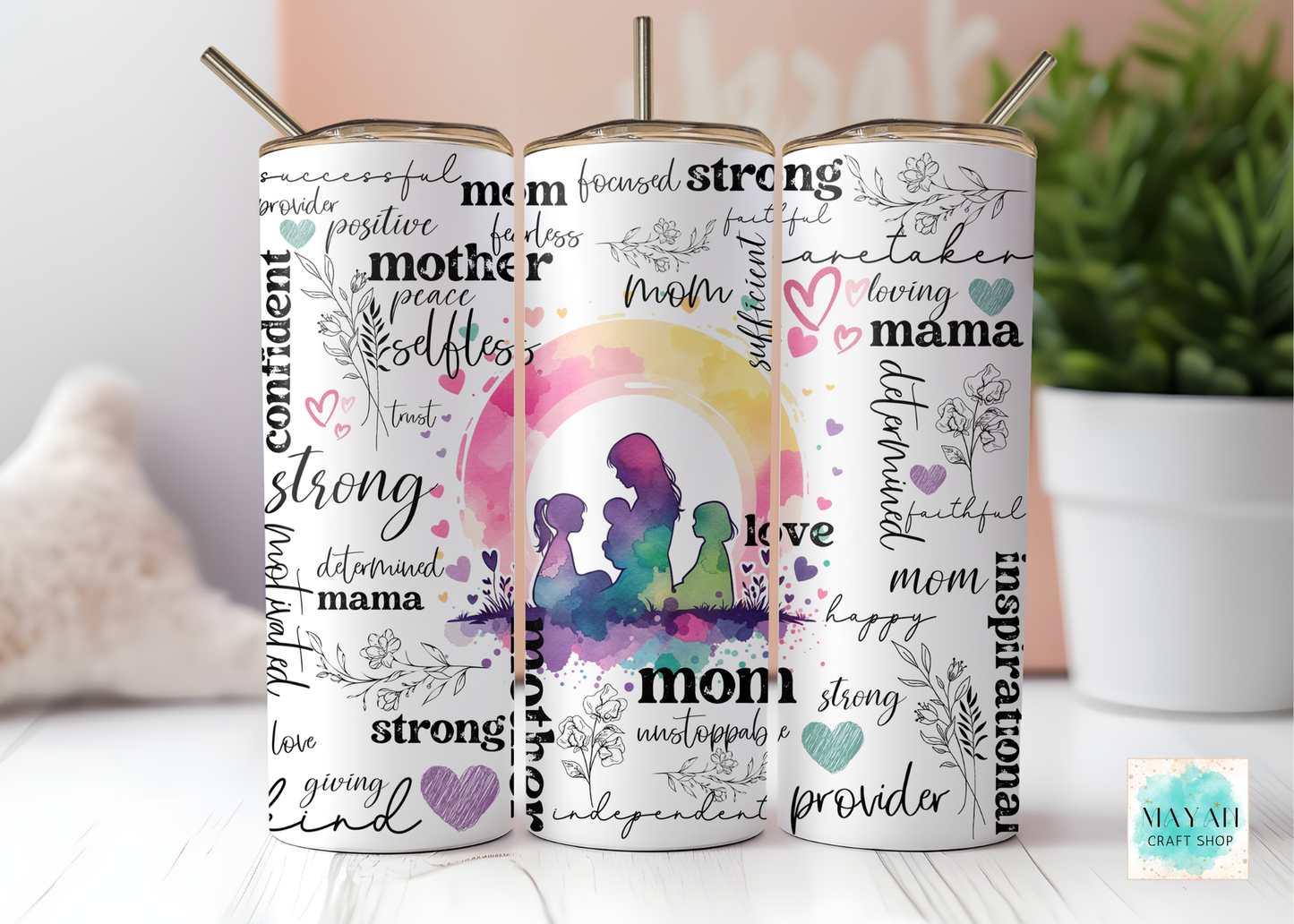 Three tumblers with motivational phrases and silhouettes on a white surface.