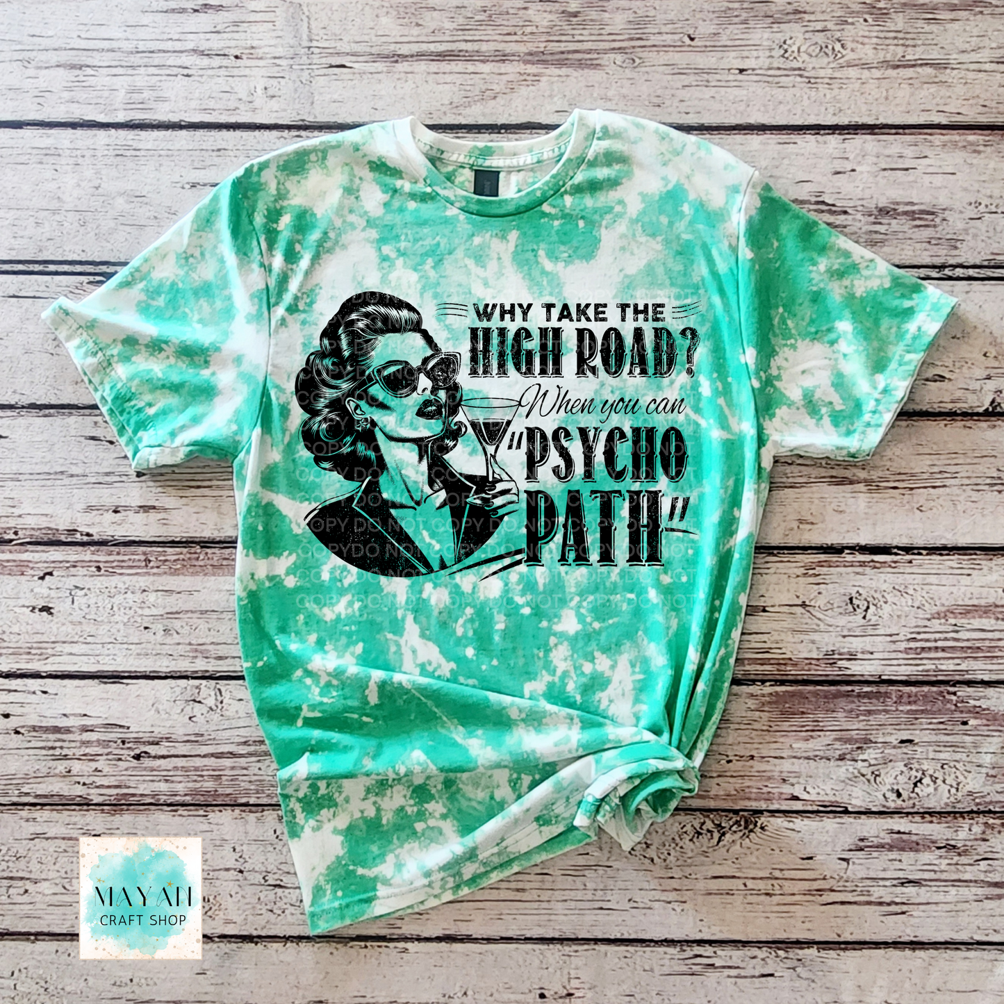 Tie-dye t-shirt with graphic design and text on a wooden surface