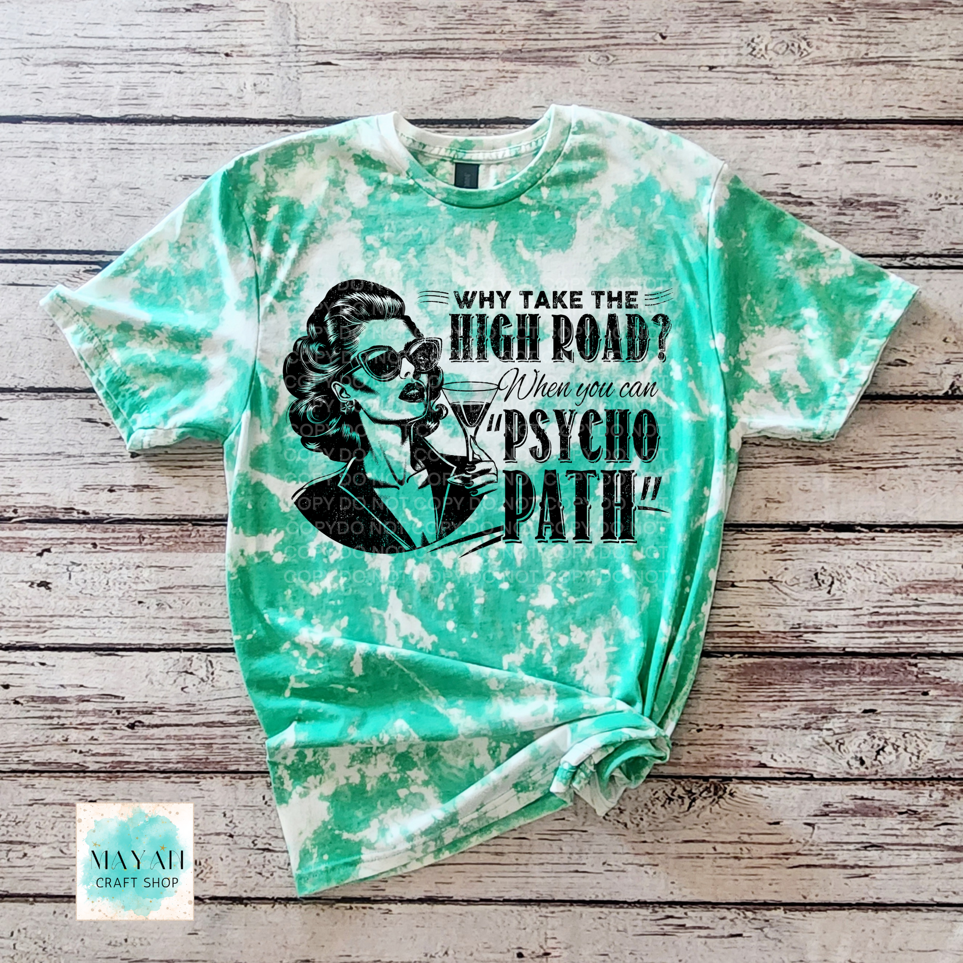 Tie-dye t-shirt with graphic design and text on a wooden surface