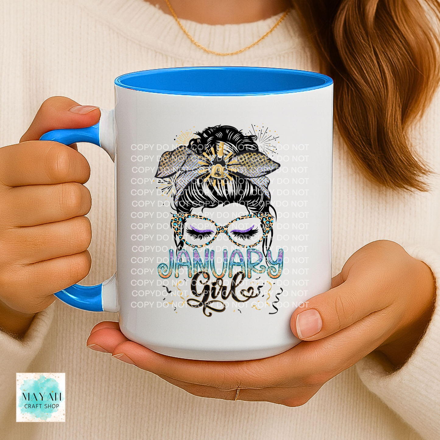 Person holding a mug with 'January Girl' design and blue interior