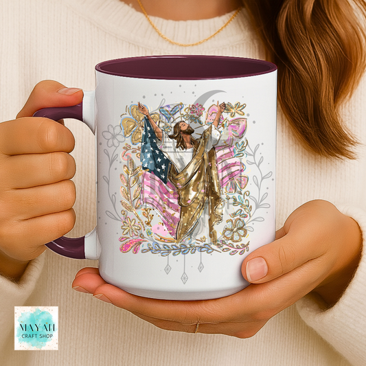 Person holding a mug with a colorful design of a man holding an American flag.