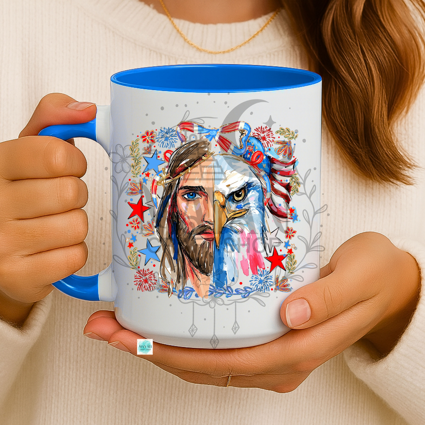Person holding a mug with a colorful design of a face and eagle, featuring red, blue, and white colors.