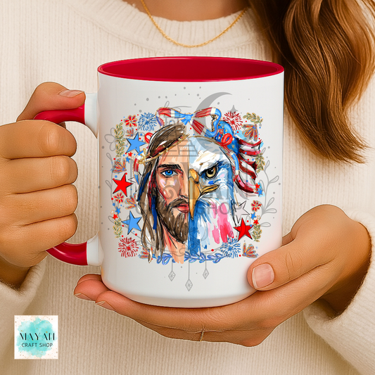 Person holding a mug with a colorful design of a face and eagle, featuring red, white, and blue colors.