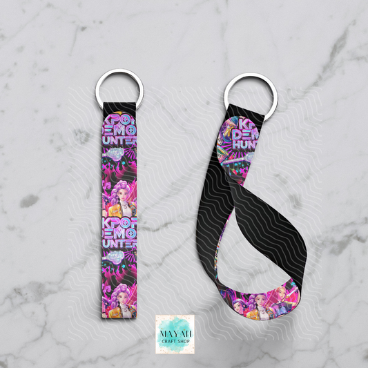 Keychain strap with colorful design and text on a marble background