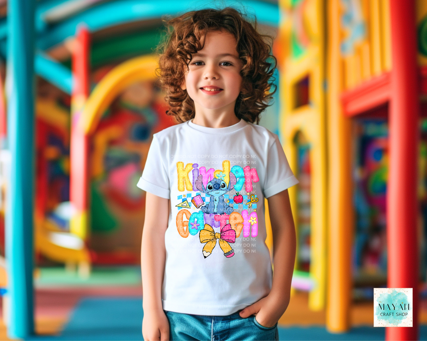 Child wearing a colorful t-shirt with cartoon characters in an outdoor playground setting