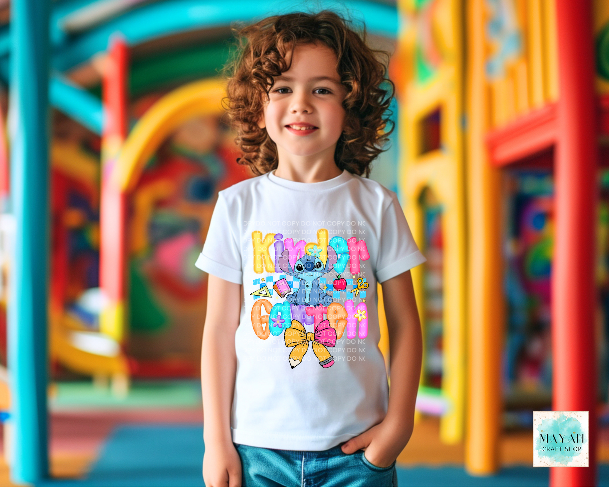 Child wearing a colorful t-shirt with cartoon characters in an outdoor playground setting
