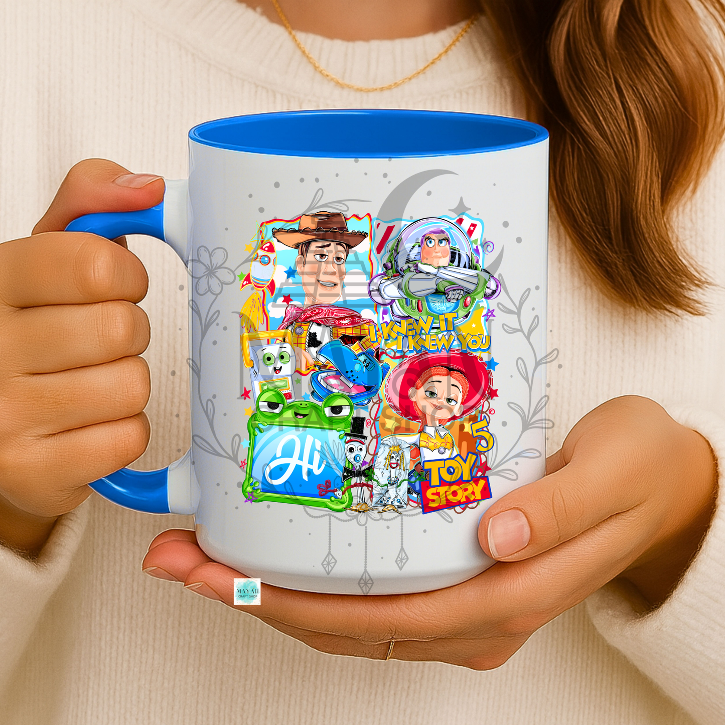 Person holding a mug with character designs
