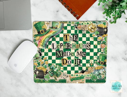 Laptop with a decorative cover featuring leprechauns and text on a marble surface.