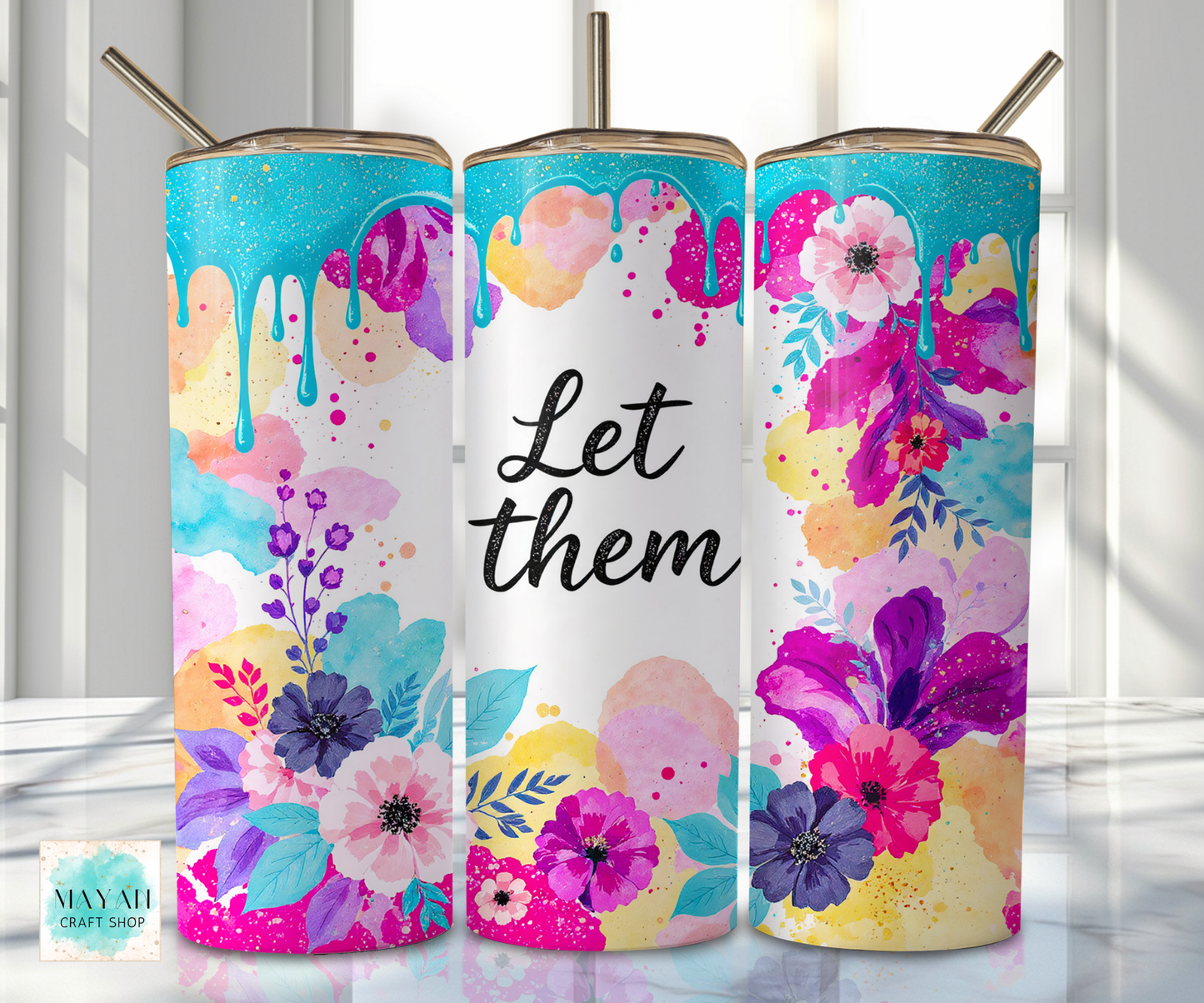 Three colorful tumblers with floral designs and a central one with 'Let them' text.