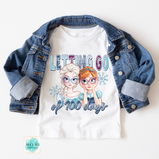 White t-shirt with cartoon characters and text 'Letting Go of 100 Days' on a denim jacket.