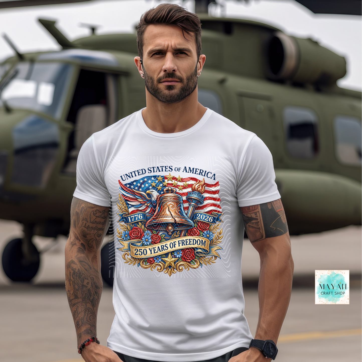 Man wearing a white t-shirt with a patriotic design in front of a helicopter.