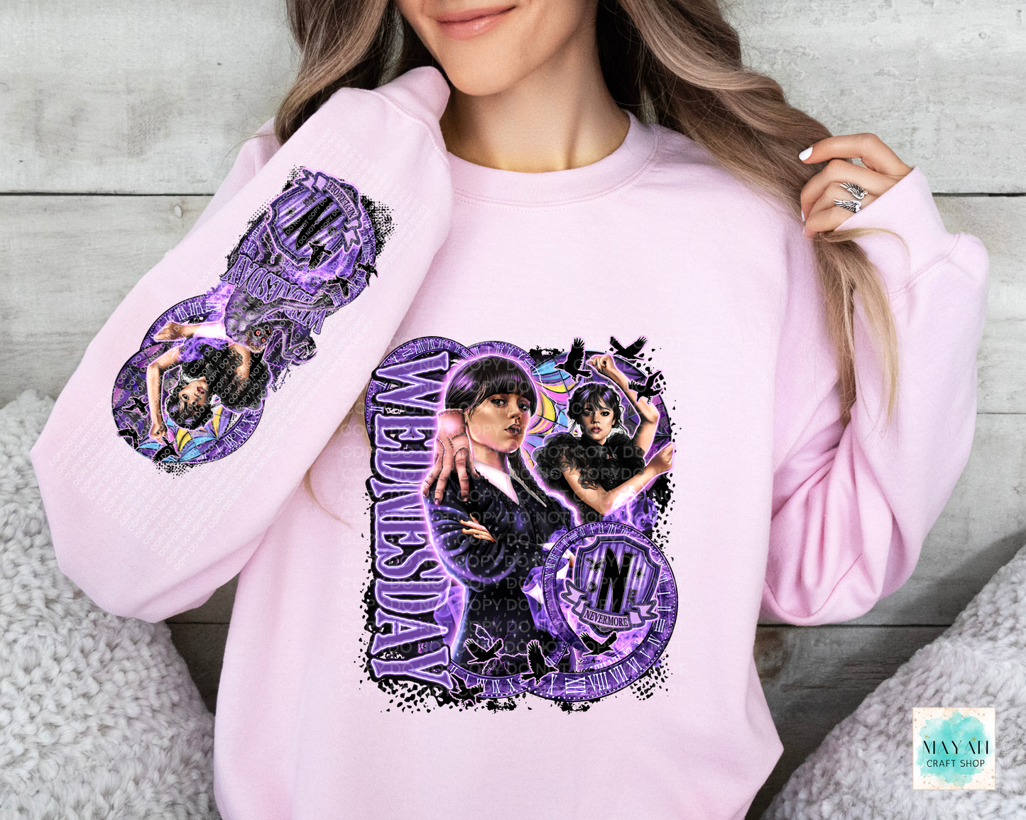 Purple design in light pink sweatshirt with sleeve design.