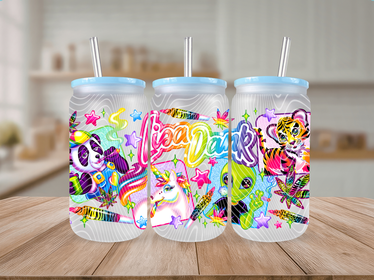 Three colorful tumblers with animal designs and straws on a wooden surface.