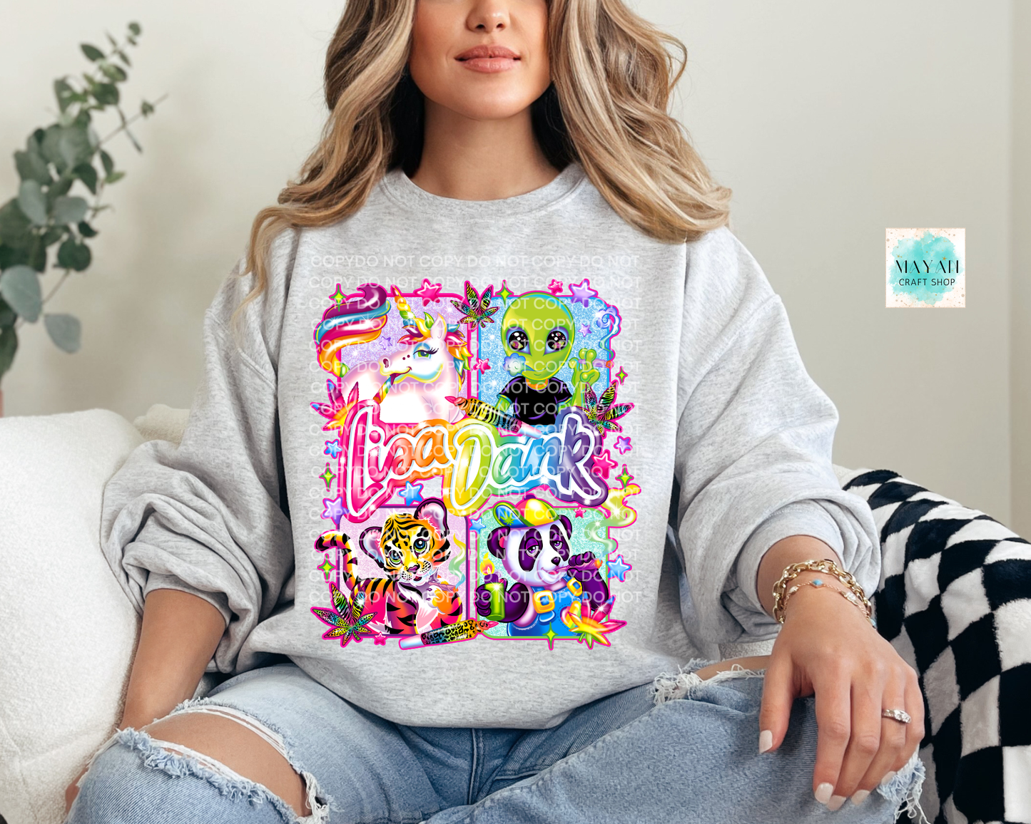Person wearing a gray sweatshirt with colorful graphic designs and text.