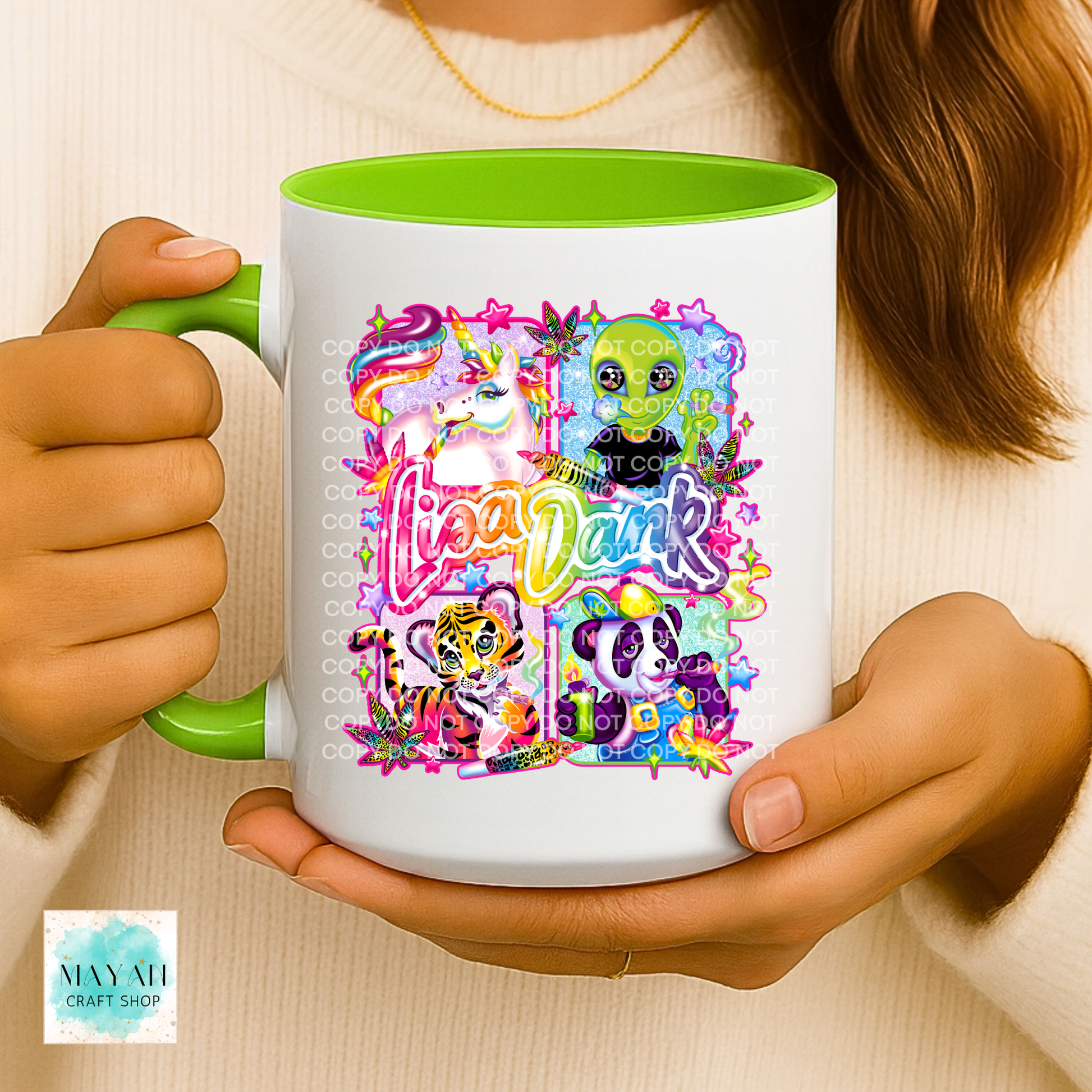 Person holding a mug with colorful design and text.