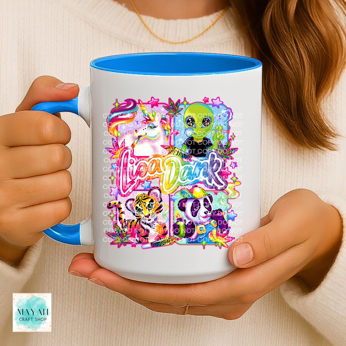 Person holding a mug with colorful character design.