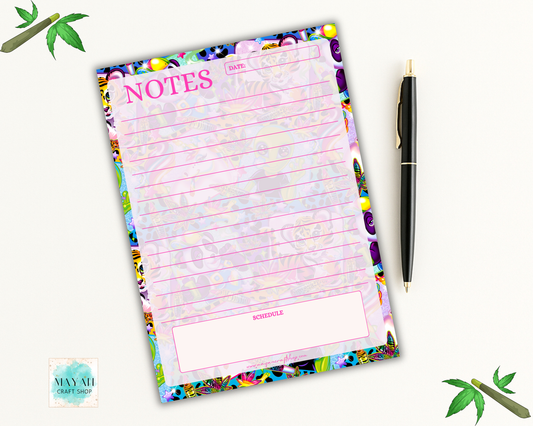 Colorful notepad with floral border and pen on a white background