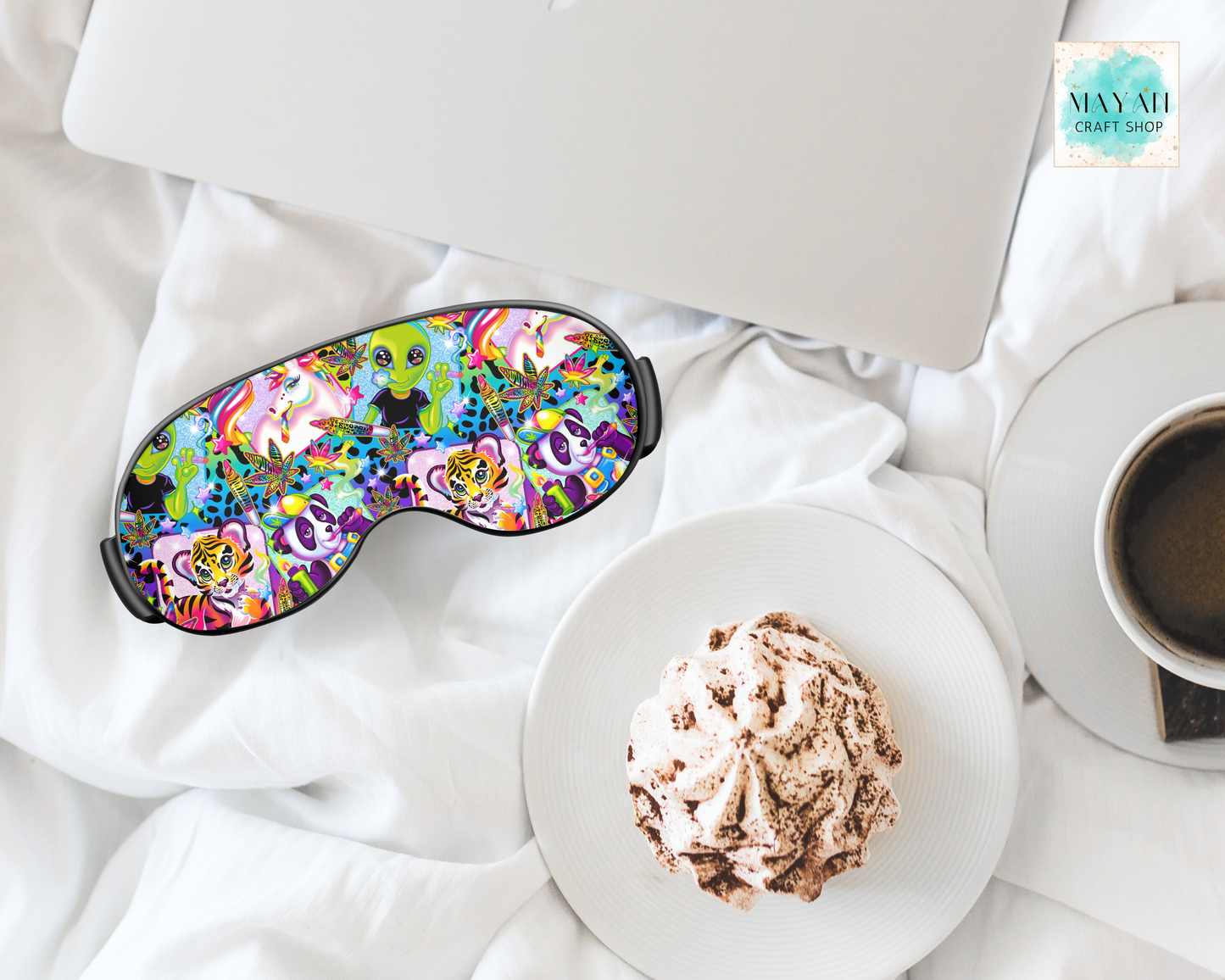 Colorful sleep mask on a white surface with a plate of food and a cup of coffee.