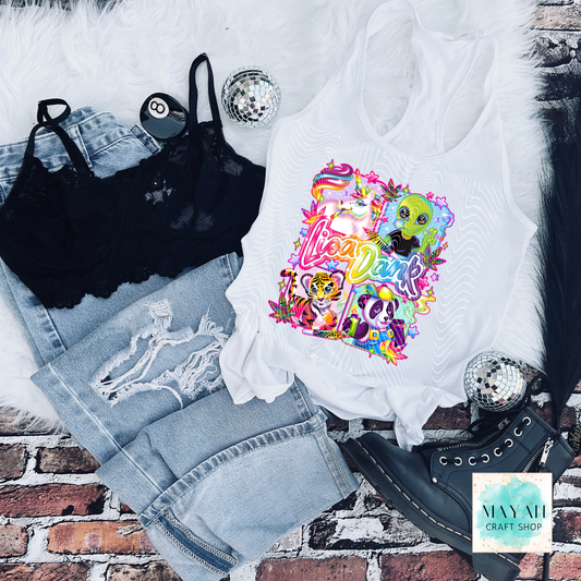 White tank top with colorful graphic design on a brick surface with jeans and black bralette.