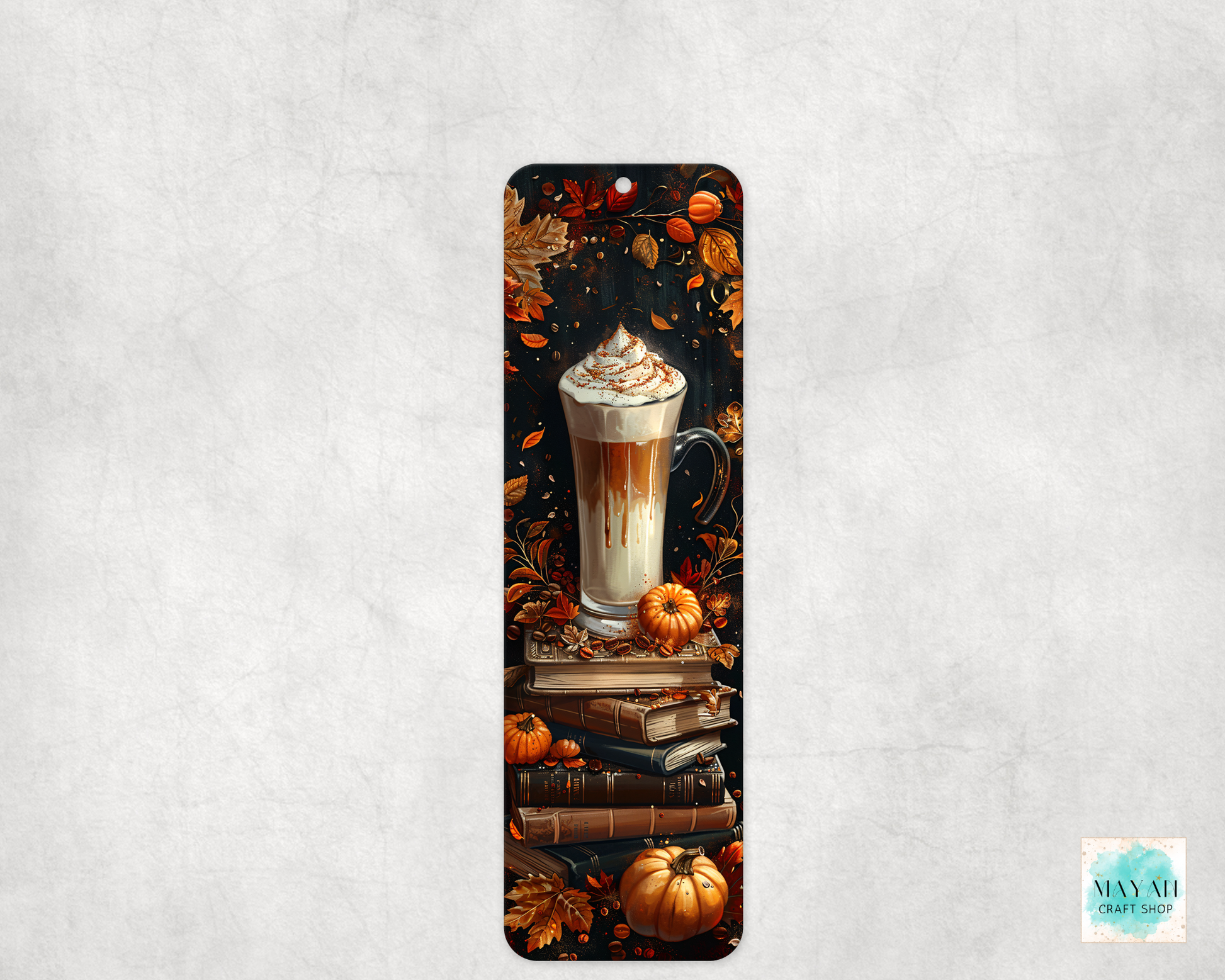 Bookmark with a design of a latte, pumpkins, and books on a textured gray background
