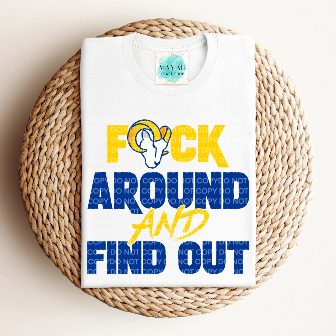 White t-shirt with colorful text and graphic on a woven mat
