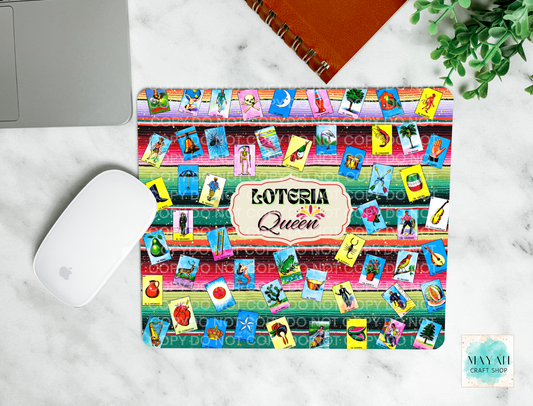 Colorful 'Loteria Queen' mouse pad on a marble surface with a laptop and mouse.