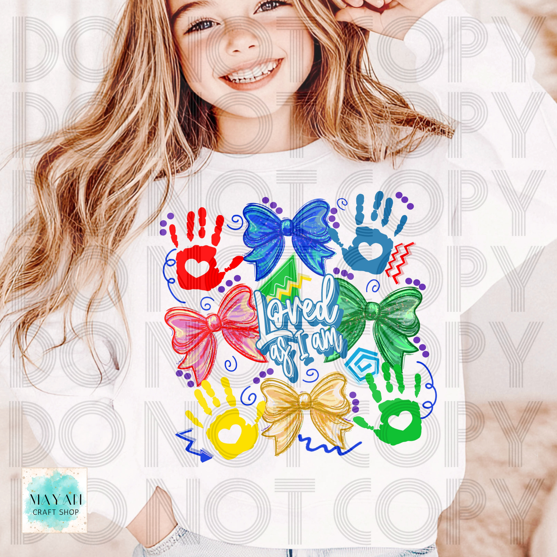 Child wearing a shirt with colorful designs and text, with a visible brand logo in the corner.