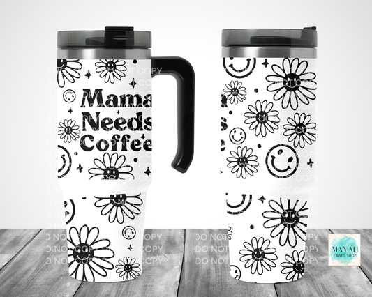 Two travel mugs with floral and text design on a wooden surface.