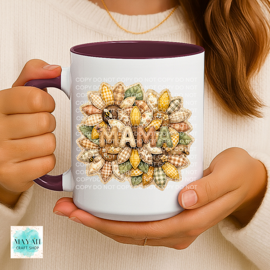 Person holding a mug with a decorative 'MAMA' design, featuring a brand logo in the corner.