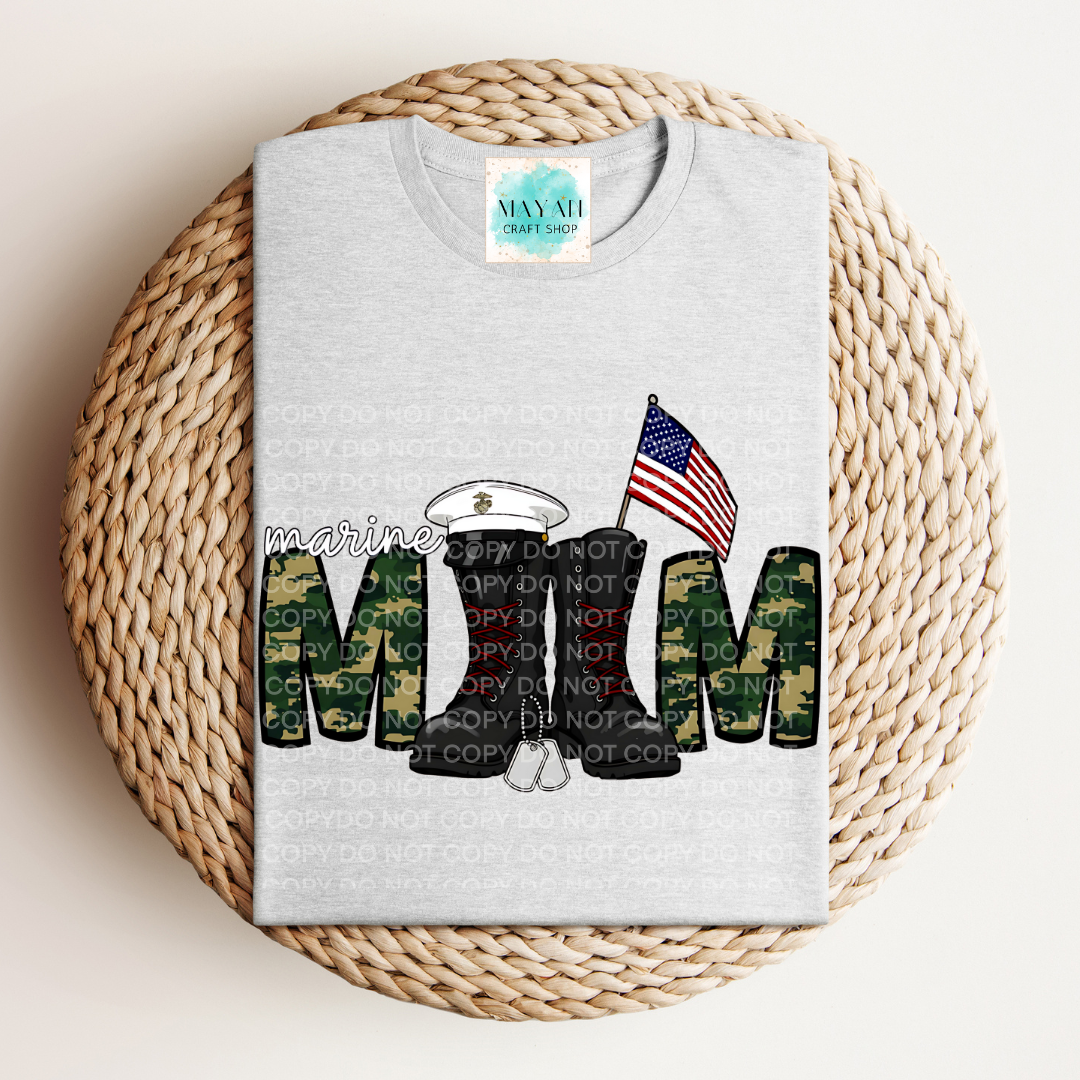 Gray t-shirt with military mom design featuring camouflage letters and American flag on a woven mat.