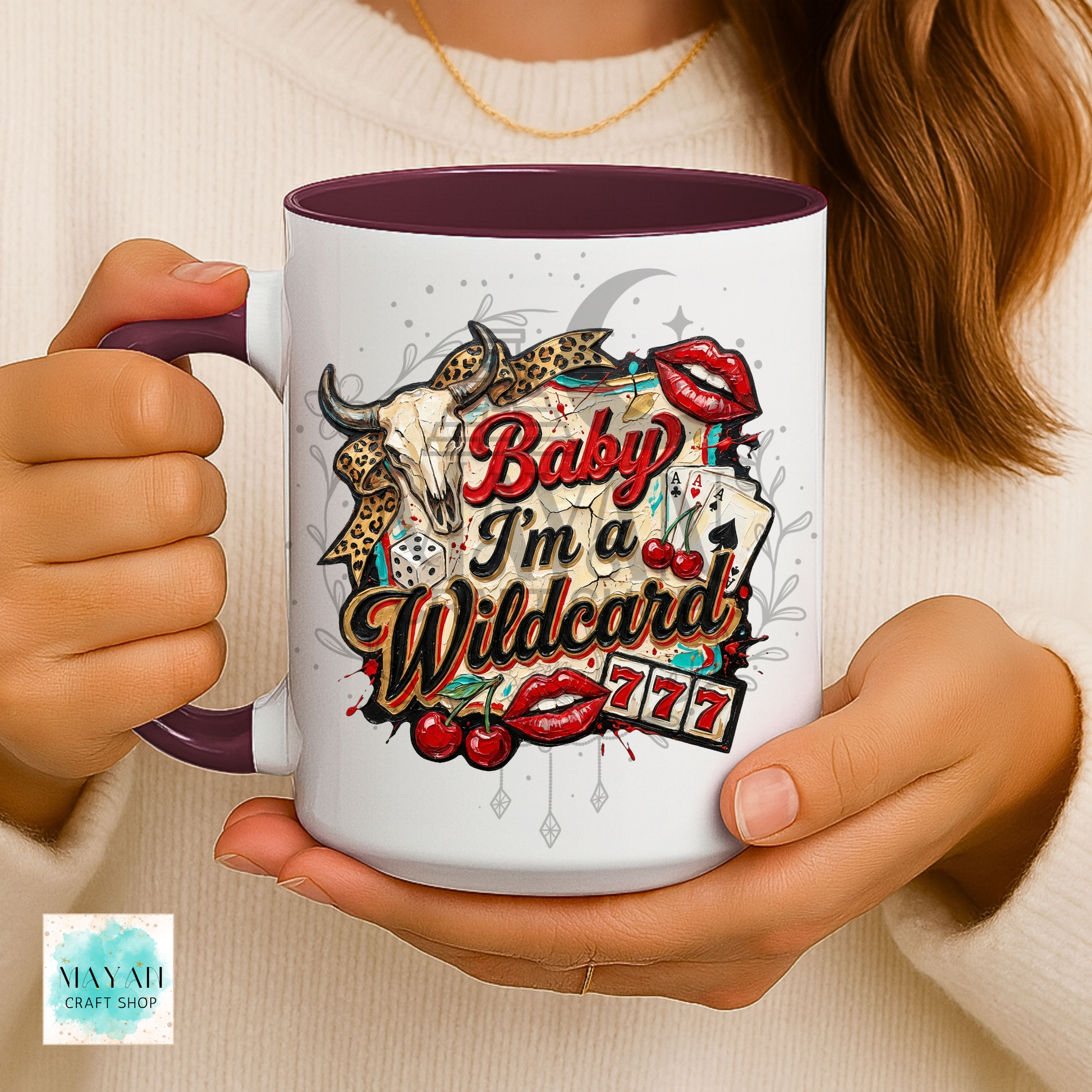 Person holding a mug with 'Baby I'm a Wildcard' design