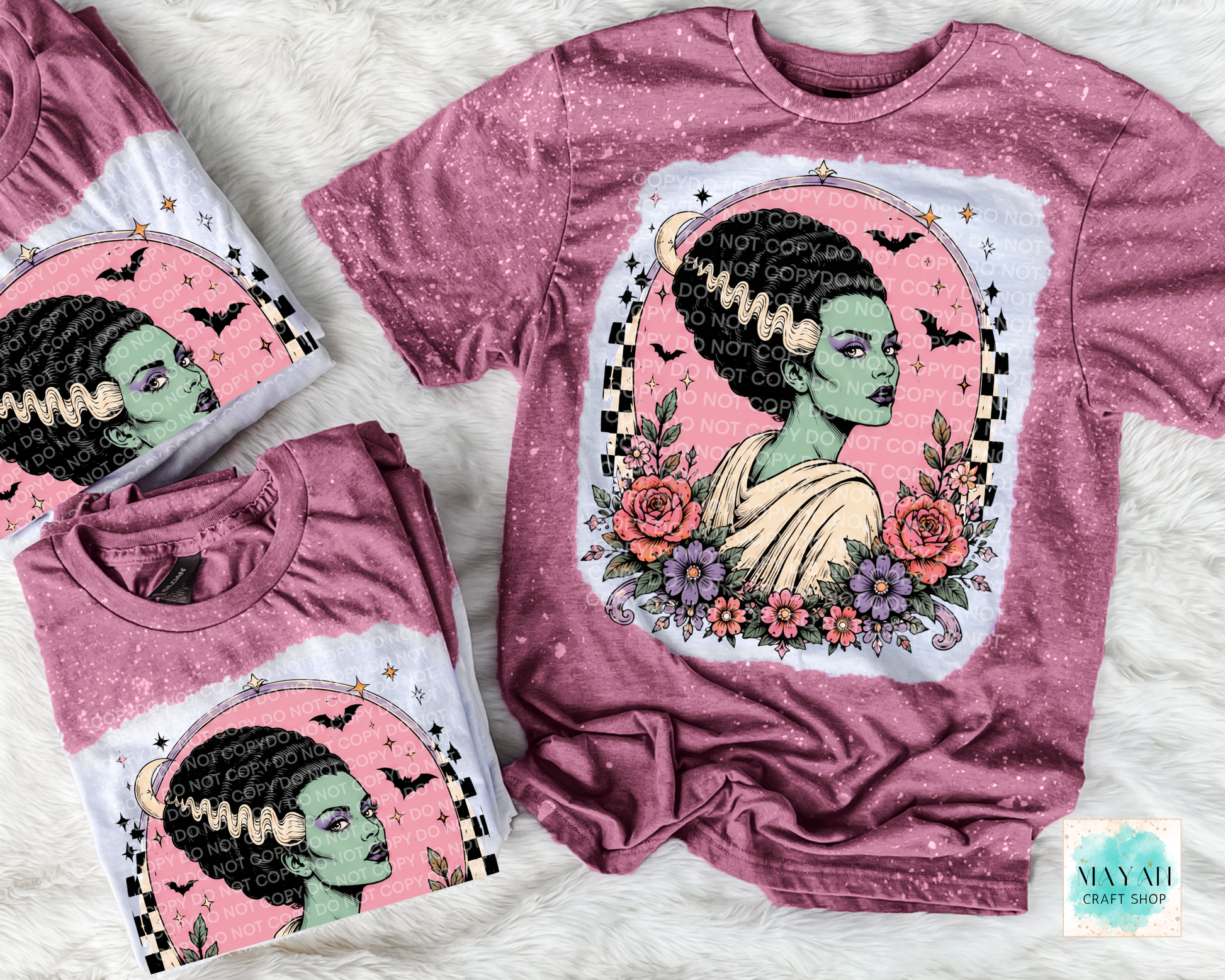 Maroon t-shirts with a graphic design of a woman with flowers and text on a white surface.