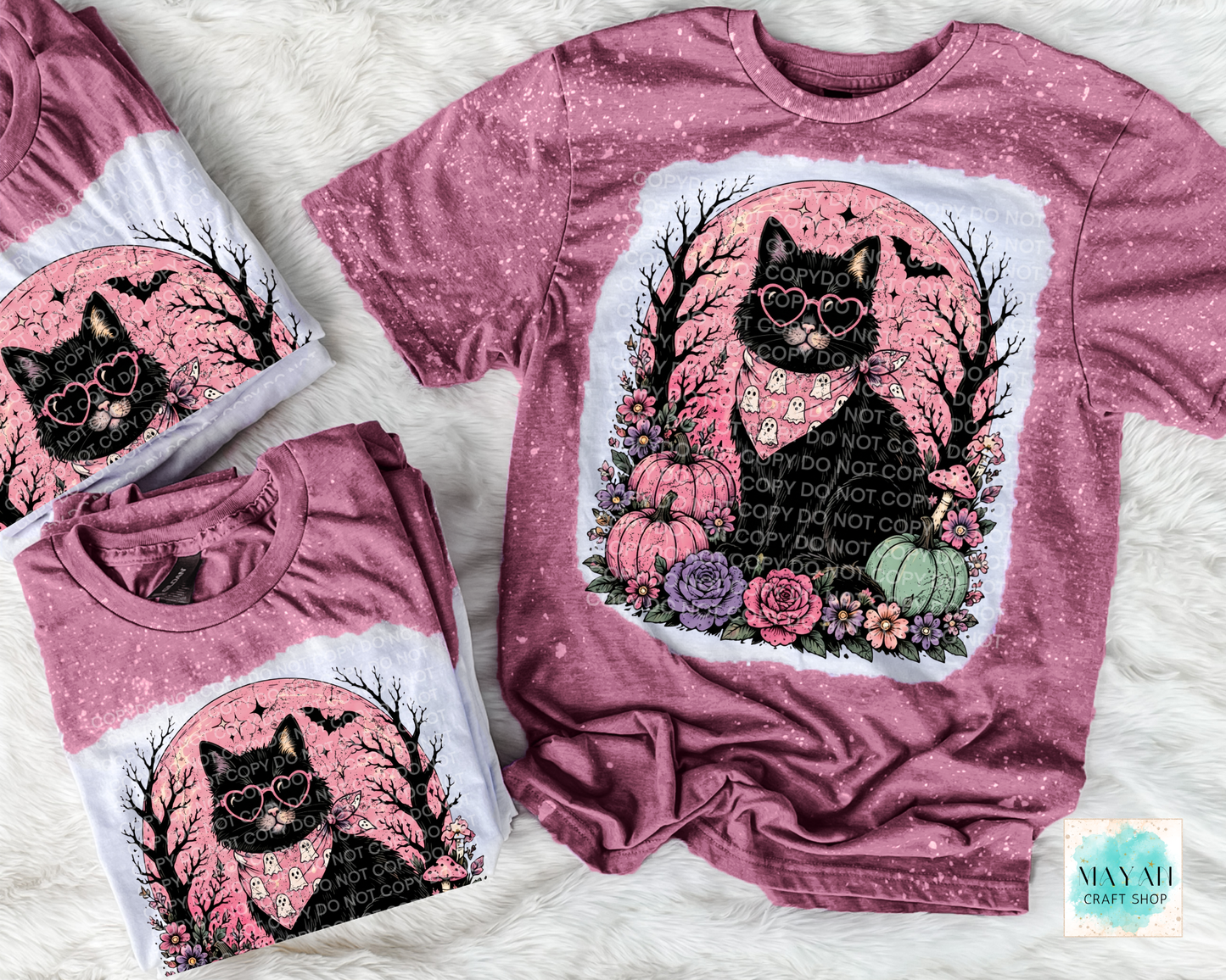 Maroon t-shirt with black cat design on a white textured background