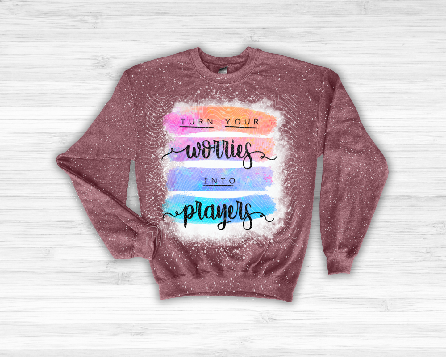 Maroon sweatshirt with motivational quote on a light wooden background