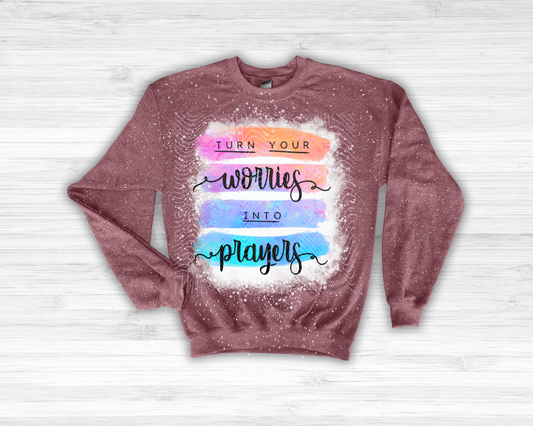 Maroon sweatshirt with motivational quote on a light wooden background