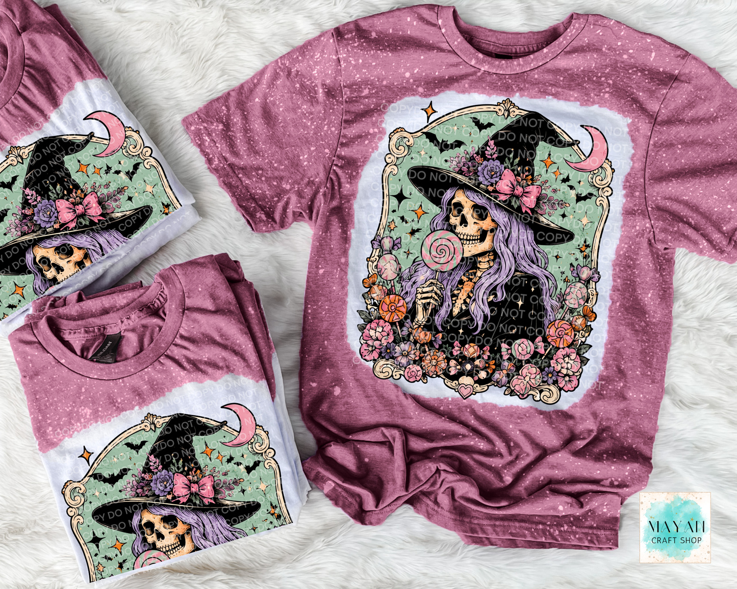Maroon t-shirt with skeleton and floral design on a textured surface