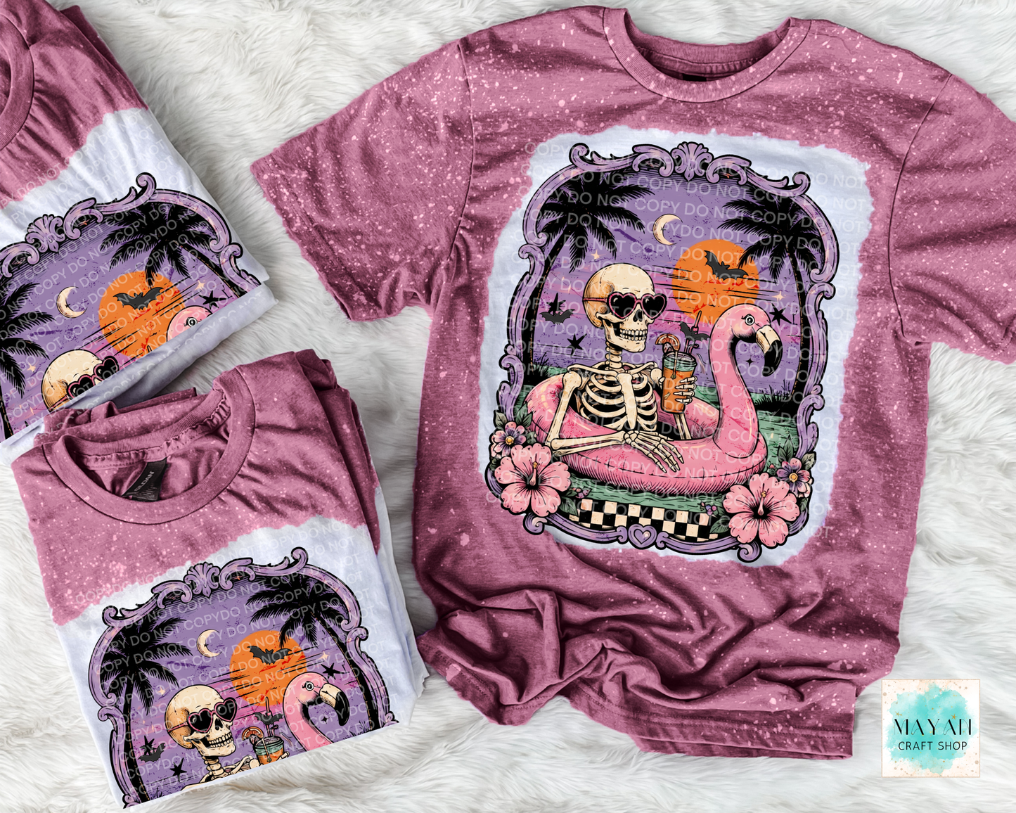 Maroon t-shirt with a skeleton and flamingo design on a textured surface