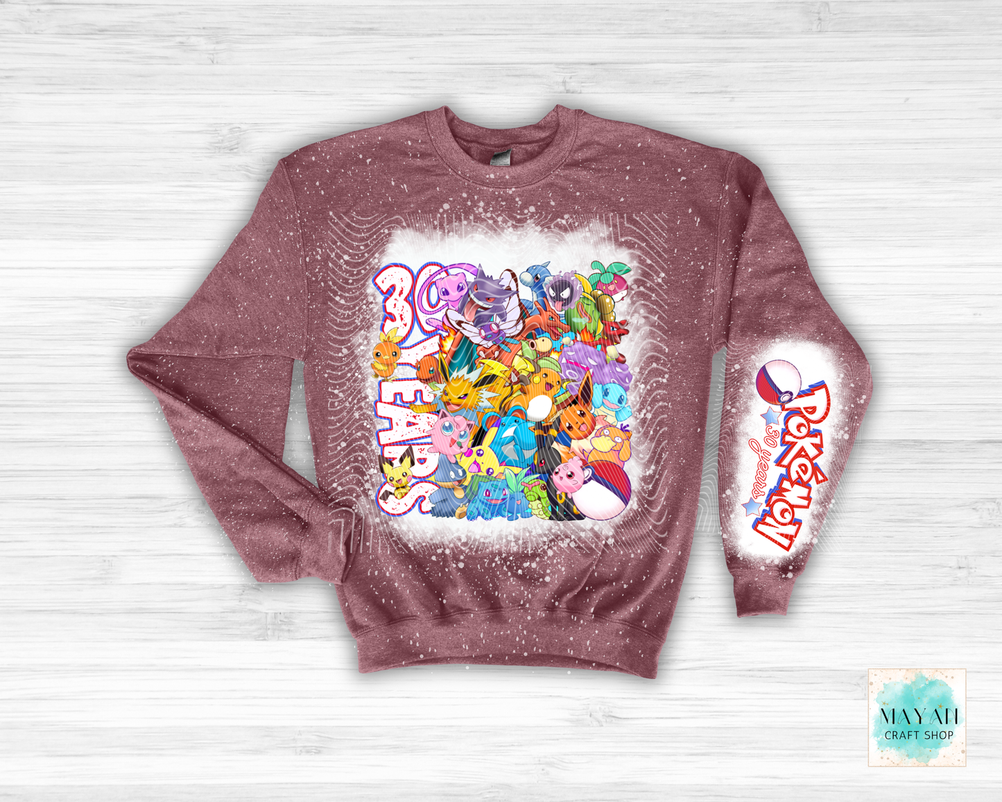 Sweatshirt with colorful graphics and text on a light wooden background