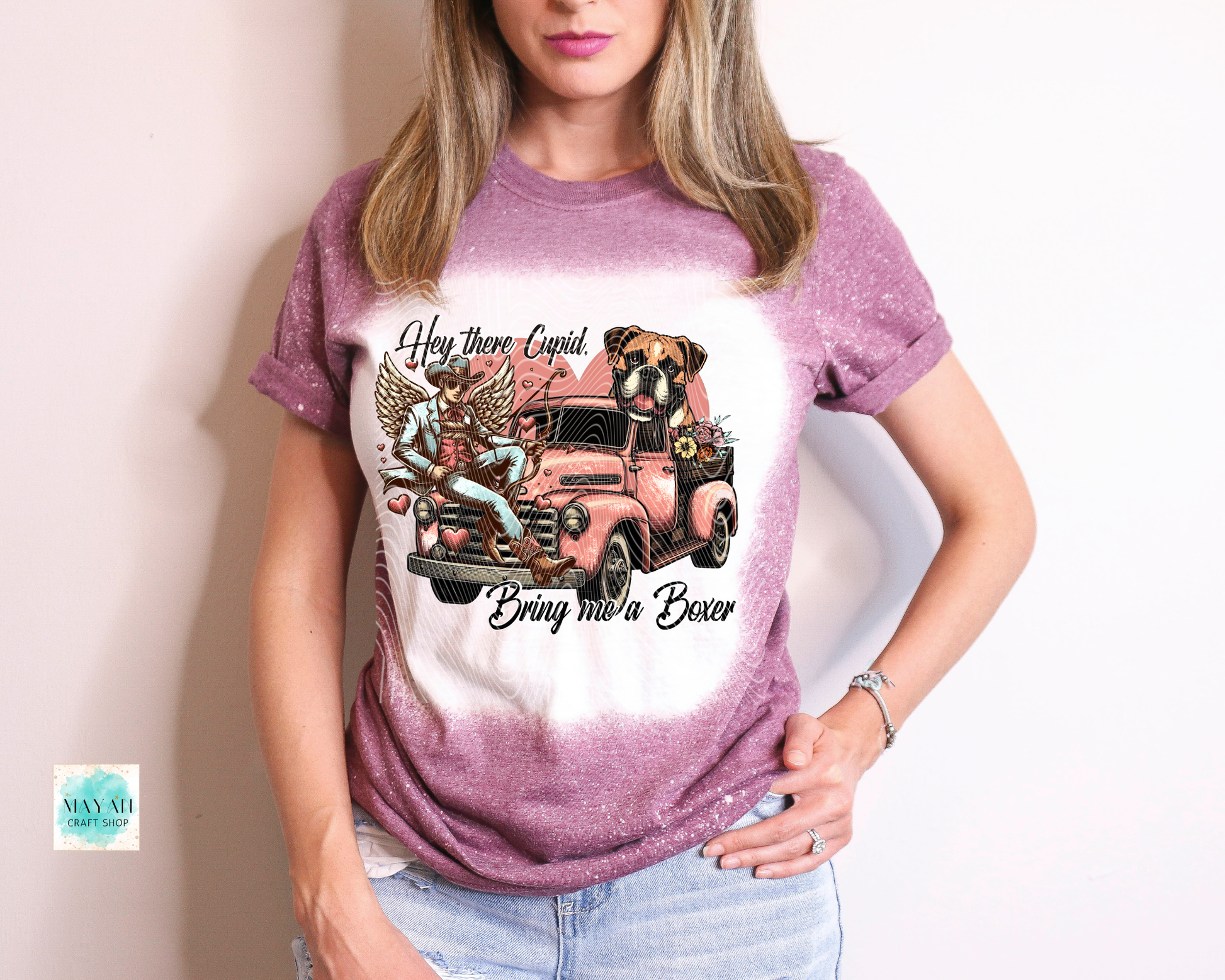 Woman wearing a t-shirt with a graphic design of a truck and dogs.