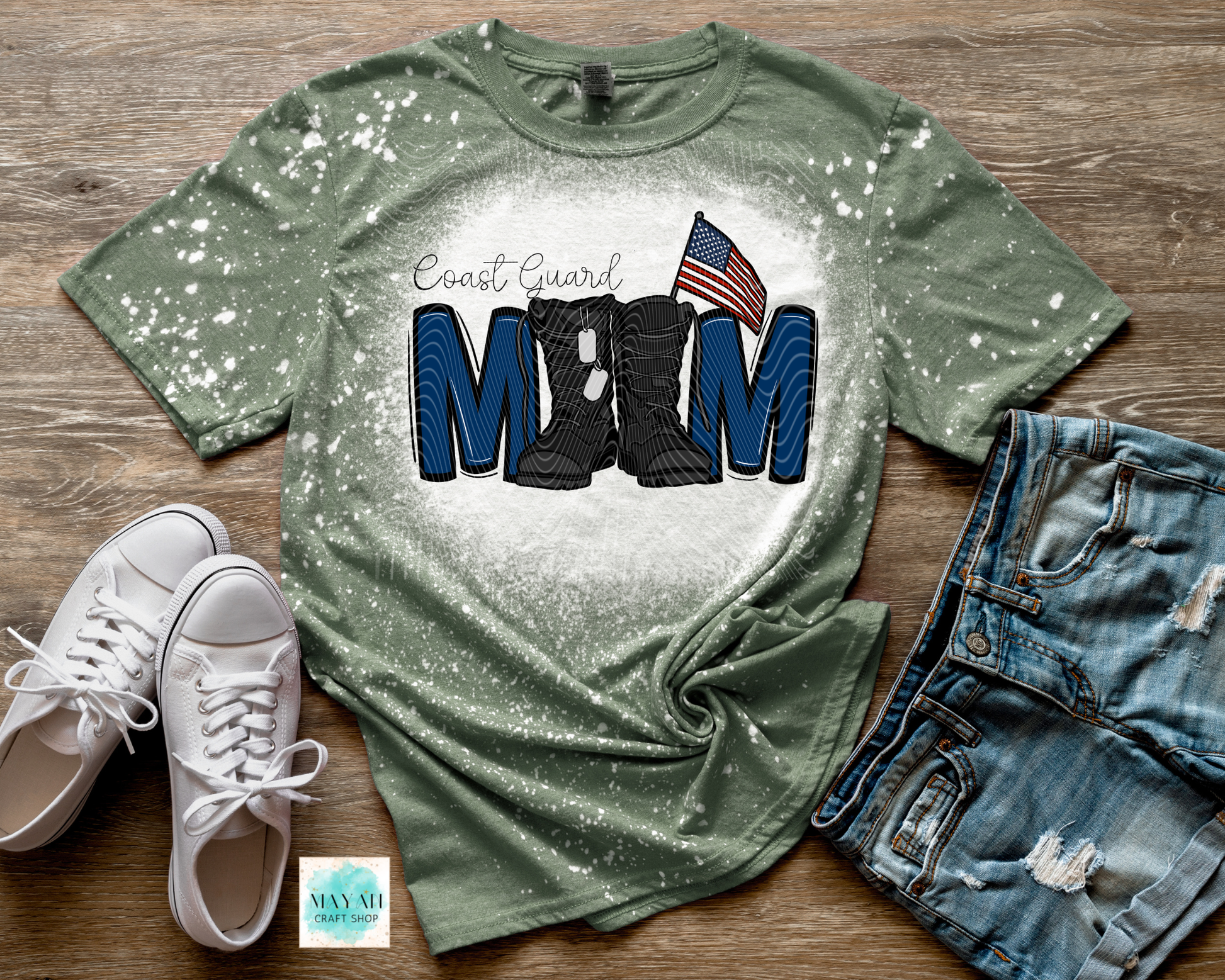 Green t-shirt with military mom design on a wooden surface with shoes and shorts.