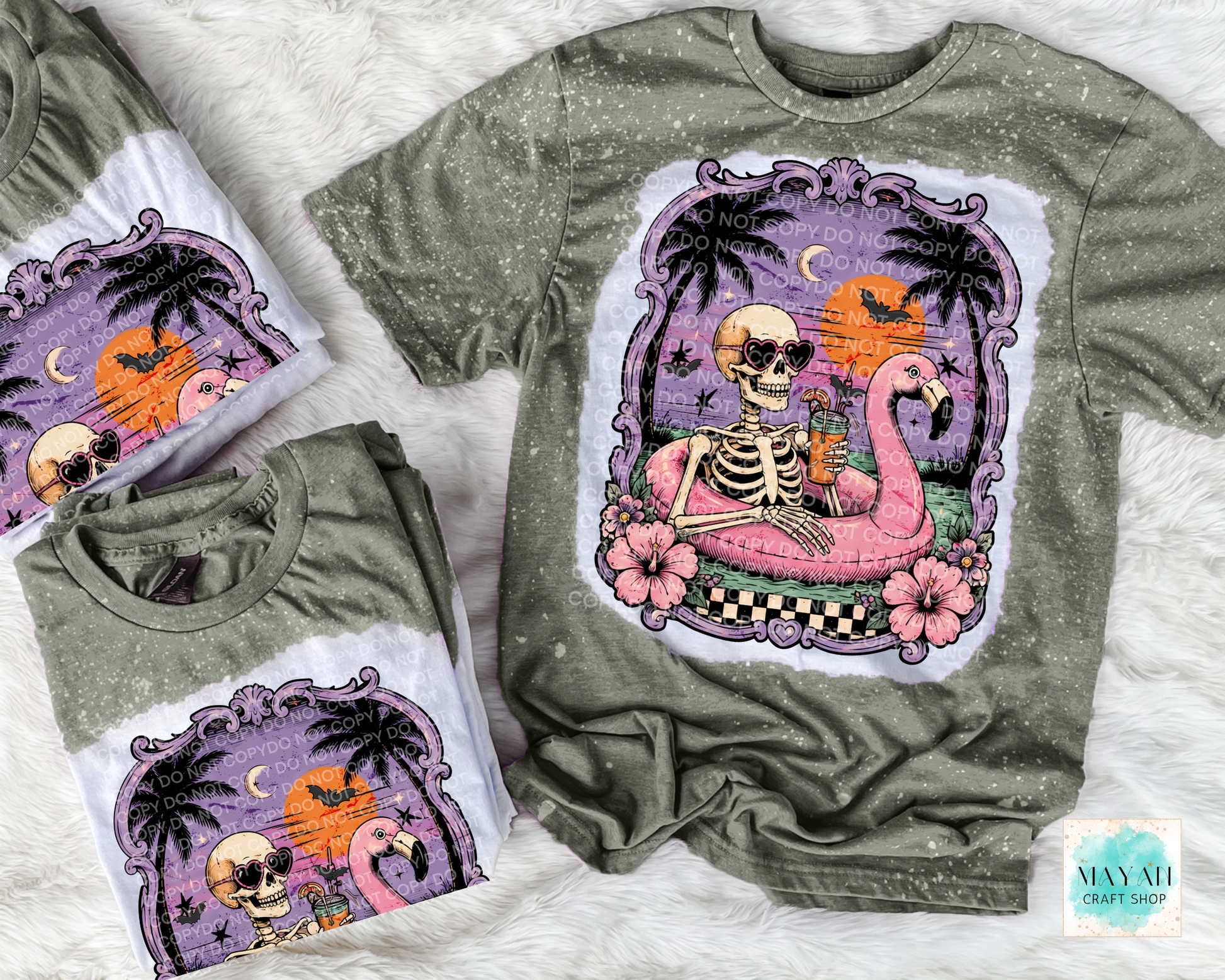 Military green t-shirts with a colorful skeleton and flamingo design on a white surface.