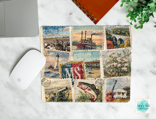 Collage of vintage stamps on a mouse pad with a laptop and mouse in the background.