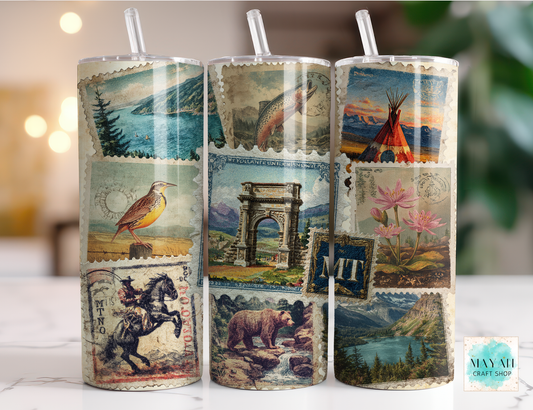Three cylindrical tumbler with vintage-style illustrations on a blurred background