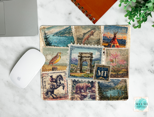Mouse pad with vintage-style postage stamp design on a marble surface.