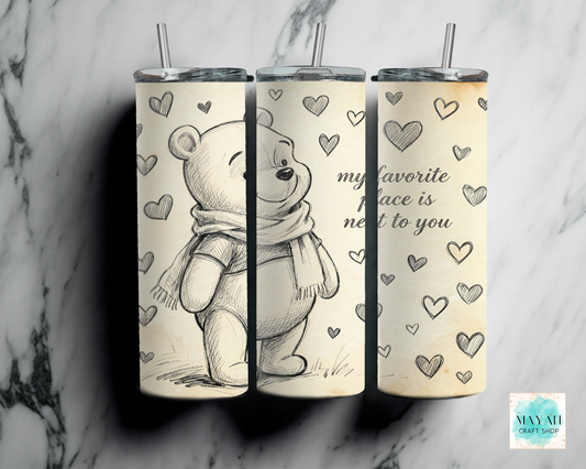 Three tumblers with a bear design and heart patterns on a marble background