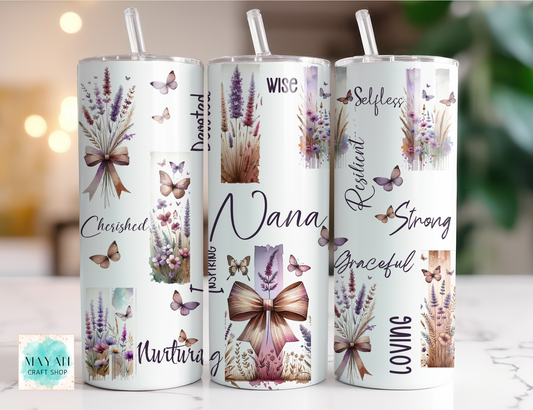 Three tumblers with floral and butterfly designs and motivational phrases on a blurred background.