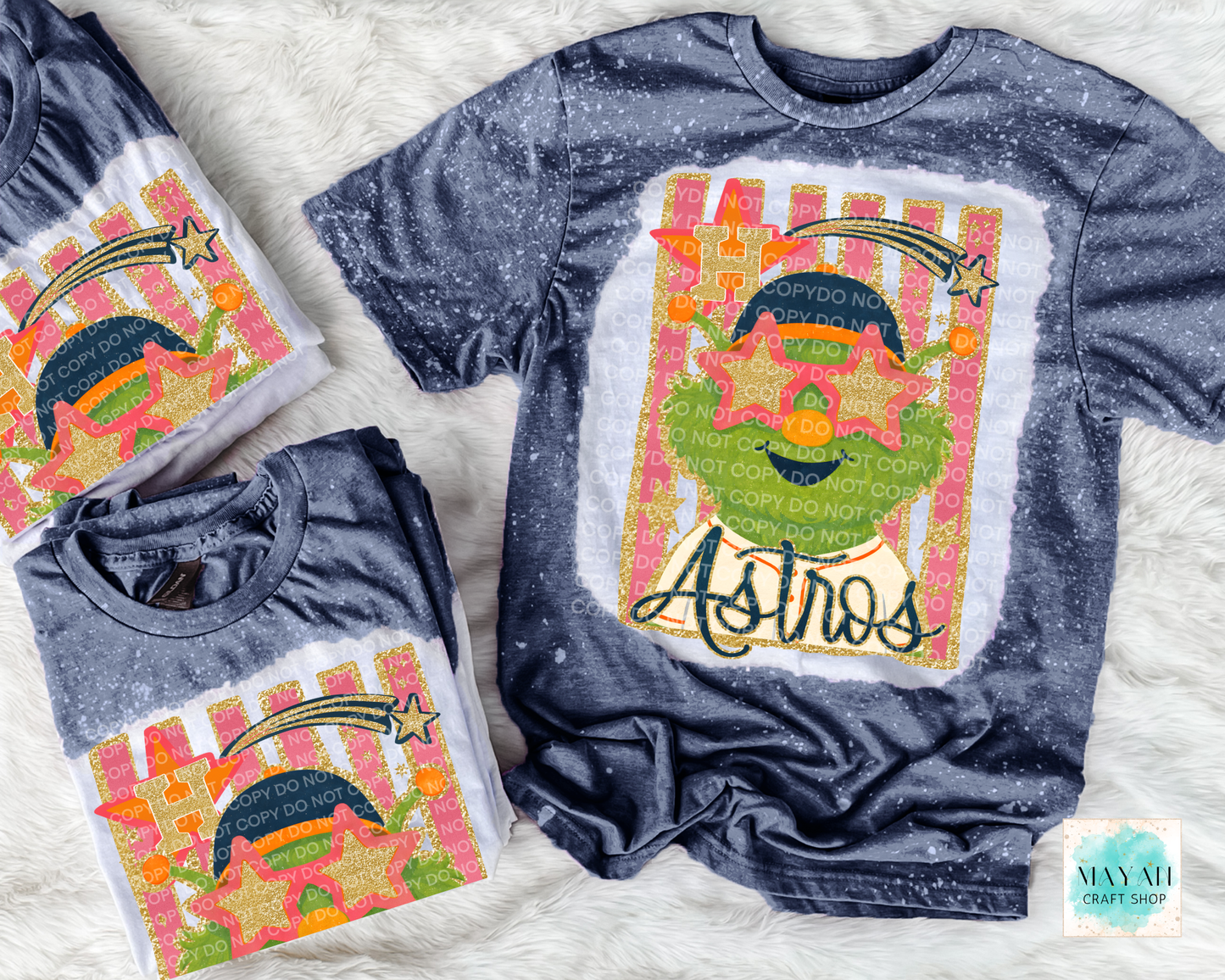 Two blue t-shirts with colorful graphics and text on a white textured background