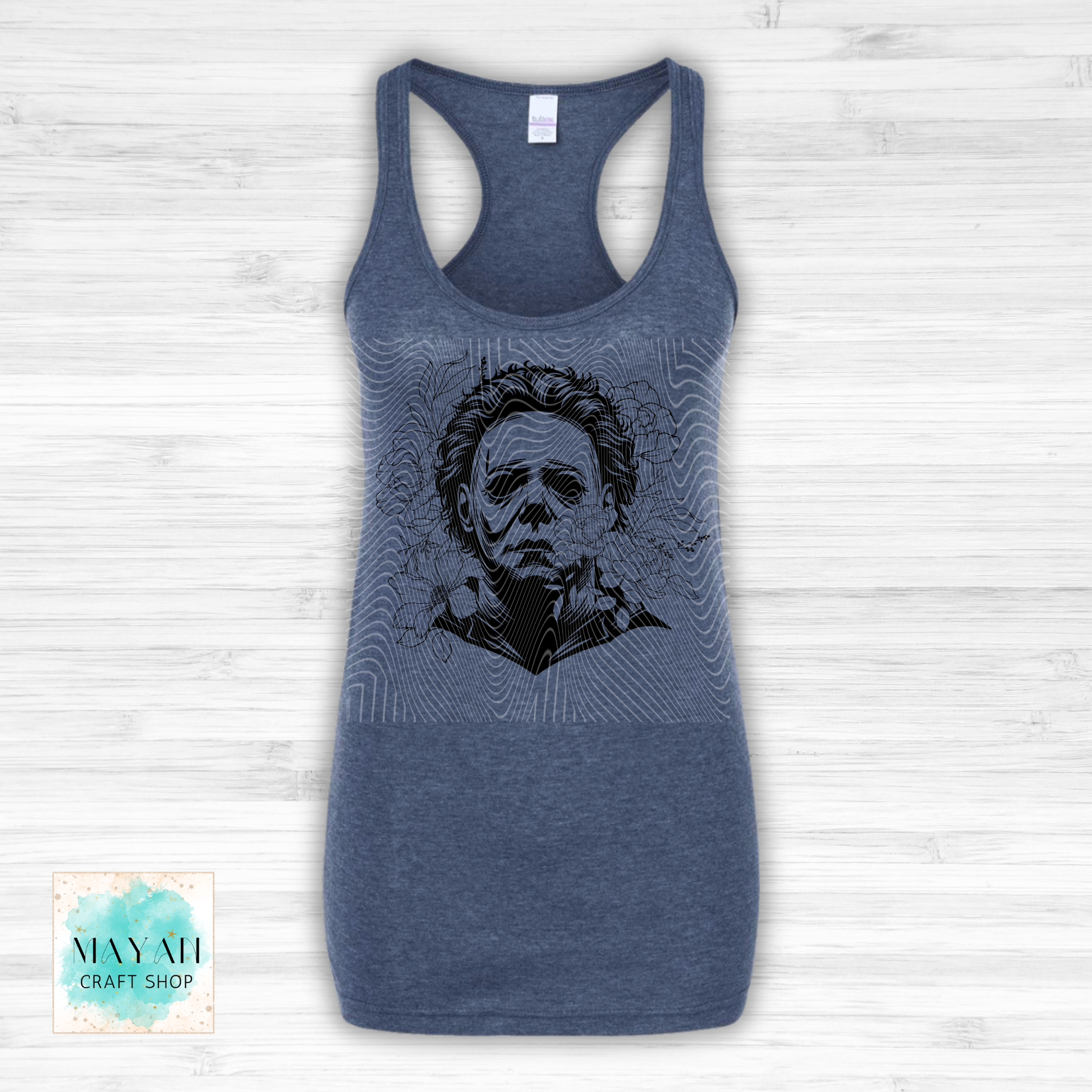 Blue tank top with a graphic design on a white wooden background