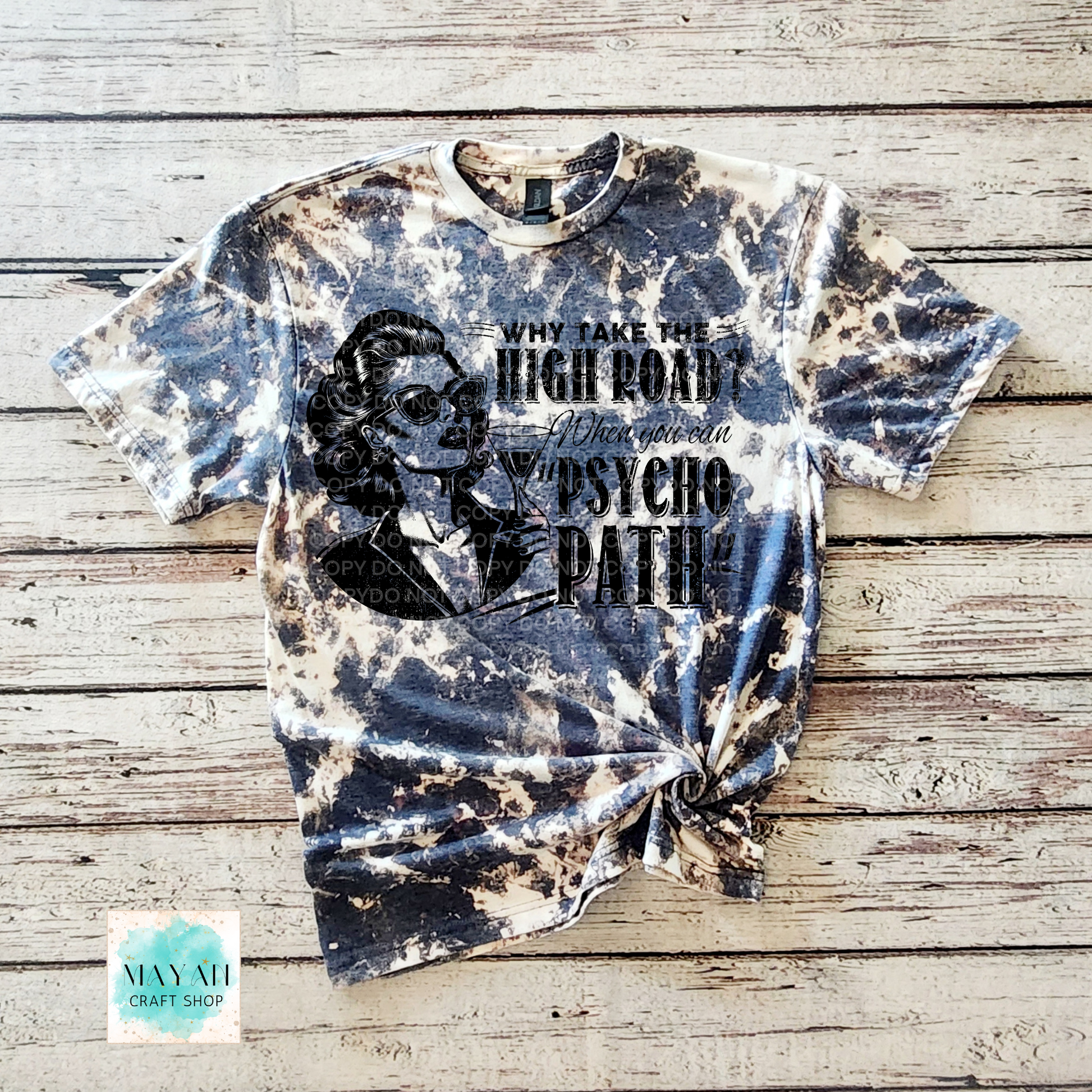 Bleached t-shirt with graphic design and text on a wooden surface